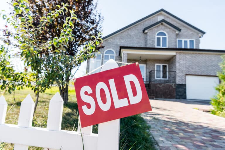 beautiful-new-house-with-sign-sold-hanging-on-fenc-2024-11-17-13-43-39-utc (1)
