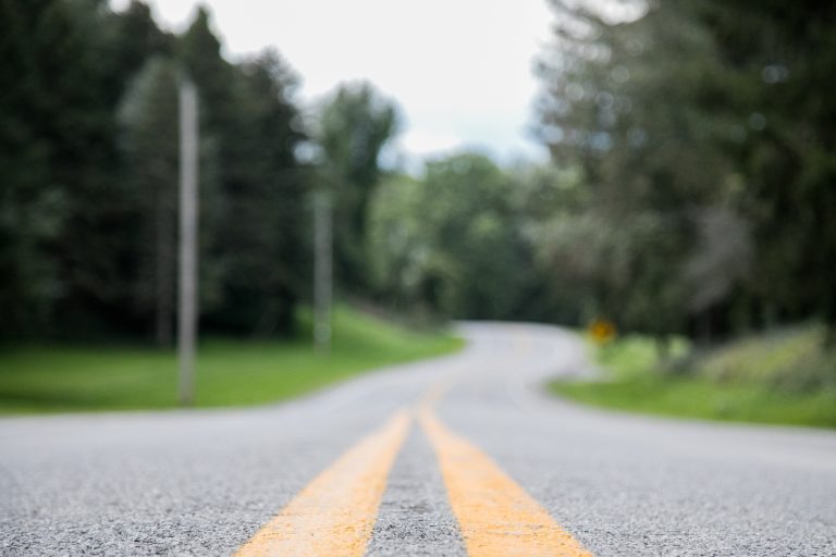 Closeup shot of an empty road with a blurred background