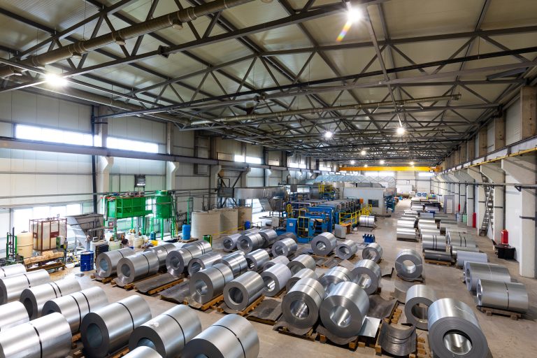 Photo of production line of metal tile for roof. Steel forming machine in metalwork factory workshop